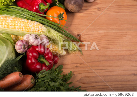 Assortment of fresh raw vegetables on a wooden table. Healthy food Top view background with empty space. 66969268