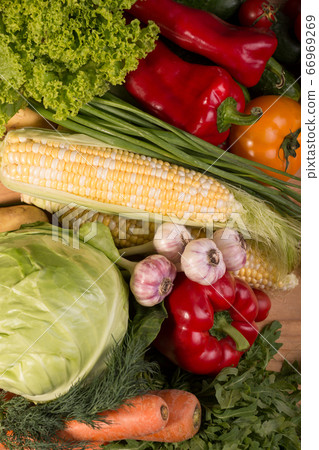 Assortment of fresh raw vegetables on a wooden table. Healthy food Top view background with empty space. 66969269