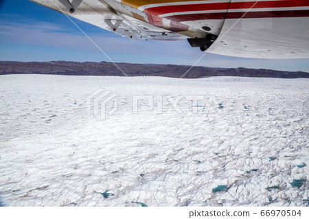 Greenlandic melting ice sheet glacier aerial view 66970504