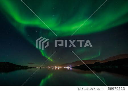 Green Northern lights reflecting in the lake with 66970513
