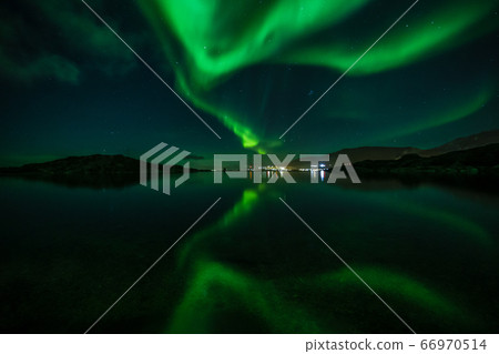 Green Northern lights reflecting in the lake with Green Northern lights reflecting in the lake with 66970514