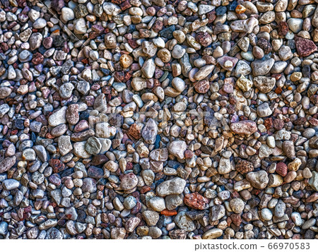 Pebble lies evenly on the seashore. 66970583