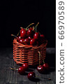 Cherry in dew drops is in a basket 66970589