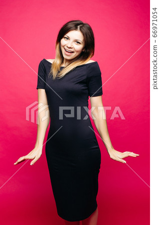 Woman in black dress lauthing emotionaly posing Woman in black dress lauthing emotionaly posing 66971054