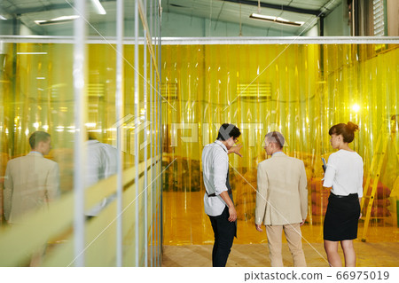 Owner showing warehouse to inspectors 66975019