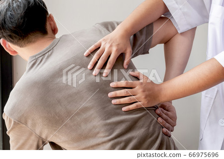 Female physiotherapists provide physical assistance to male patients with back injuries back massages for relaxation and muscle recovery in the rehabilitation center Female physiotherapists provide physical assistance to male patients with back injuries back massages for relaxation and muscle recovery in the rehabilitation center 66975696