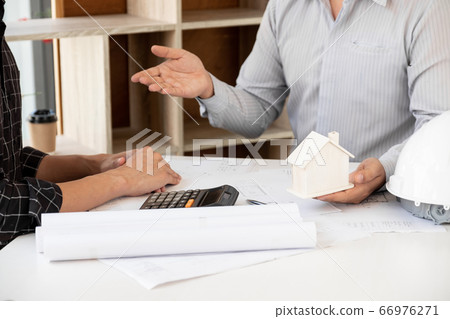 A team of confident architects working together in the office talking about construction and home design projects 66976271