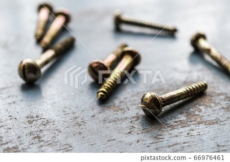 Screw on rusty metallic surface. Close Up.  66976461