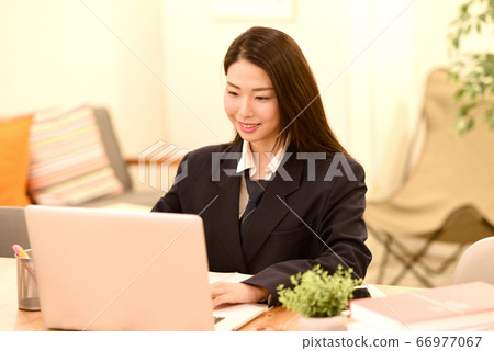 Female student operating a PC 66977067
