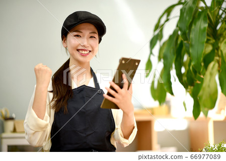 A clerk doing a guts pose A clerk doing a guts pose 66977089