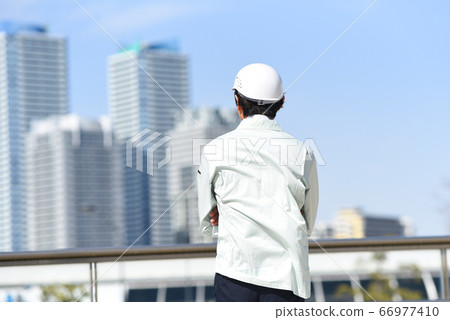 Back view of a man in work clothes Back view of a man in work clothes 66977410