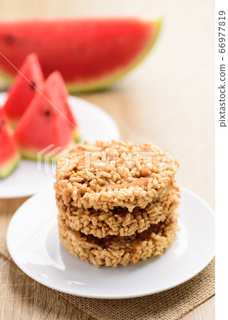 Deep fried crispy rice with watermelon juice and cane sugar drizzle,Thai snack (Khao Tan Nam Tangmo) 66977819