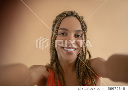 Smiling young African American female making selfie Smiling young African American female making selfie 66979846