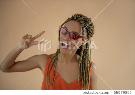 Smiling young African American showing gesture of peace Smiling young African American showing gesture of peace 66979895