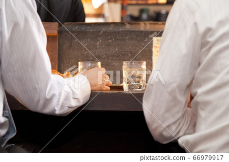 Businessman drinking at the counter 66979917