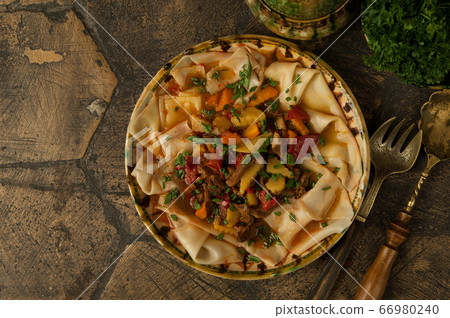 meat dish on an old paving stone meat dish on an old paving stone 66980240