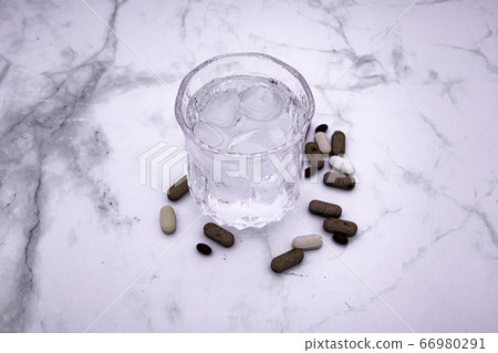 Various types of medicine and water. Various types of medicine and water. 66980291