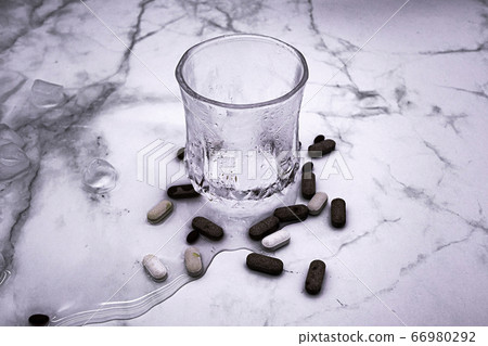 Various types of medicine and water. 66980292