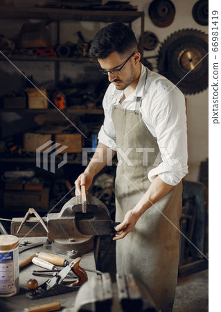 Handsome carpenter working with a wood 66981419