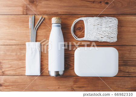 Stylish reusable eco friendly items on wooden background. Stylish reusable eco friendly items on wooden background. 66982310