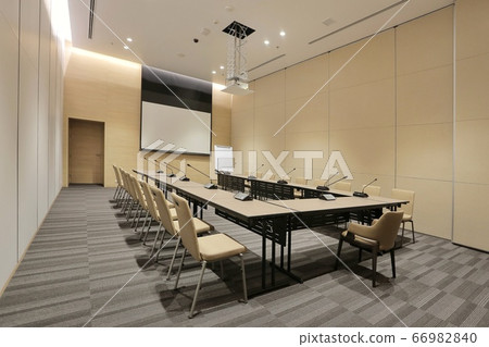 Interior of modern fully equipped professional facilities meeting conference room boardroom classroom office with nobody empty and  microphones white projector board chairs door business meeting venue 66982840