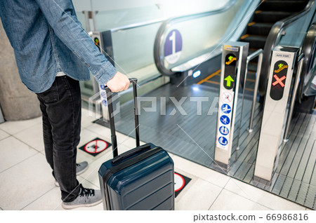 Male tourist carrying suitcase luggage at Male tourist carrying suitcase luggage at 66986816
