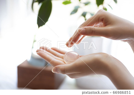 Gesture of female hand washing face with solid soap [Body parts] 66986851