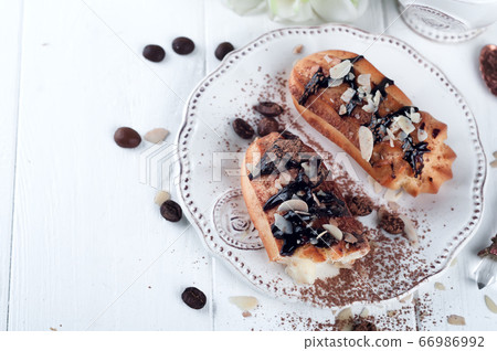 Tasty eclairs on table 66986992