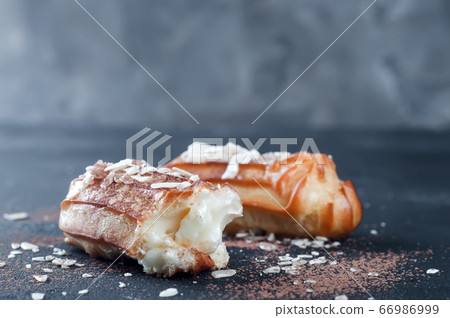 Tasty eclairs on table 66986999