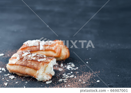 Tasty eclairs on table 66987001