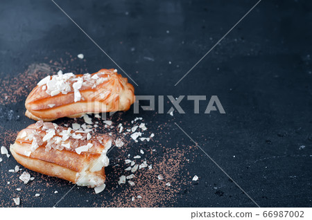 Tasty eclairs on table 66987002