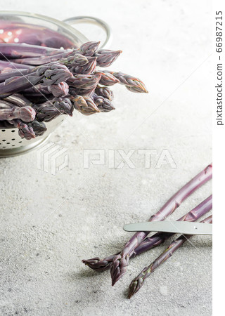 Bunch of raw organic asparagus on a board and in a Bunch of raw organic asparagus on a board and in a 66987215