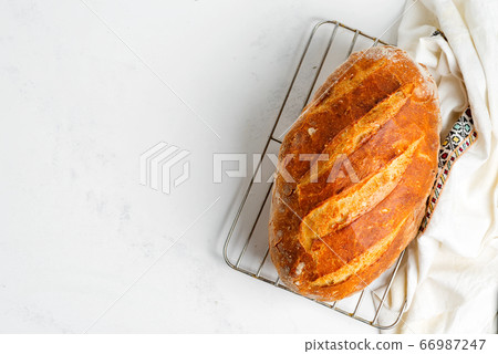 Freshy baked homemade bread on a light grey marble 66987247