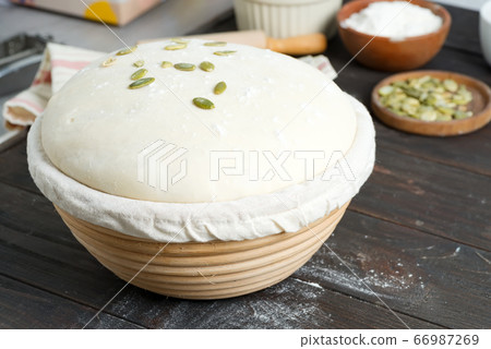 Homemade freshly prepared yeast dough in a basket Homemade freshly prepared yeast dough in a basket 66987269