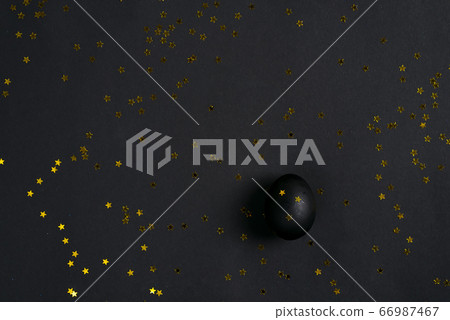 Black painted egg and stars confetti decoration on 66987467