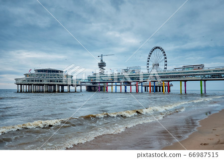The Scheveningen Pier Strandweg beach in The Hague with Ferris wheel. The Hague, Netherlands The Scheveningen Pier Strandweg beach in The Hague with Ferris wheel. The Hague, Netherlands 66987515