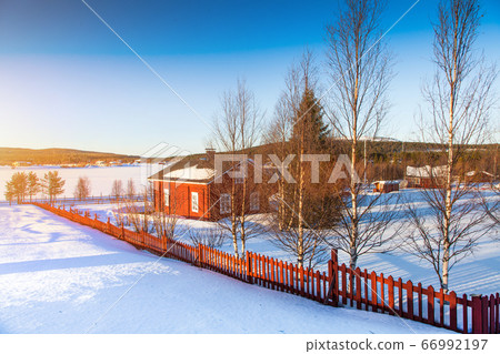 House at lake in Scandinavia at sunset 66992197