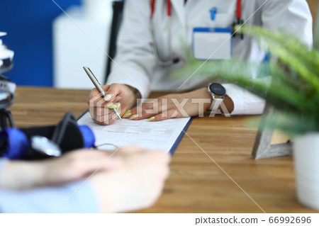 Nurse filling out form 66992696