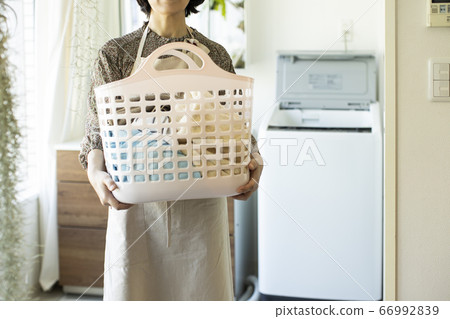 A woman with a laundry basket 66992839