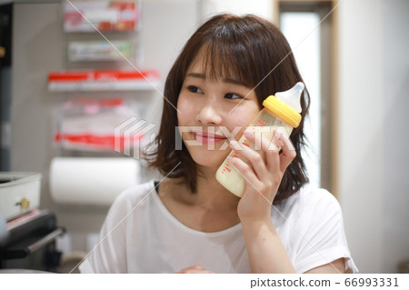 Mother checking milk temperature 66993331