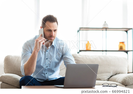 Portrait of successful businessman using phone and pc Portrait of successful businessman using phone and pc 66994821