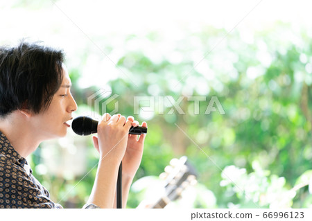 Vocalist singing at an outdoor festival Vocalist singing at an outdoor festival 66996123