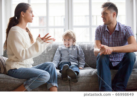 Frustrated little kid boy scared with mom and dad fighting Frustrated little kid boy scared with mom and dad fighting 66998649