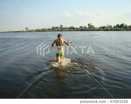 child puts river mud on his body on the river Bank child puts river mud on his body on the river Bank 67001036