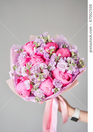 Beautiful bouquet of mixed flowers in woman hand. Floral shop concept . Handsome fresh bouquet. Flowers delivery. 67002508