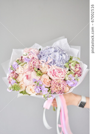 Beautiful bouquet of mixed flowers in woman hand. Floral shop concept . Handsome fresh bouquet. Flowers delivery. 67002516