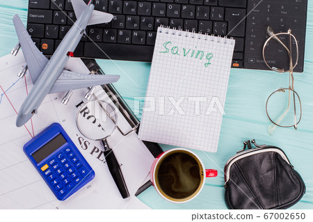 Top view of notebook cup coffee plane and eye glasses on table. Top view of notebook cup coffee plane and eye glasses on table. 67002650
