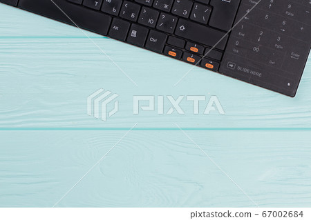 Modern computer keyboard on light blue background. Modern computer keyboard on light blue background. 67002684