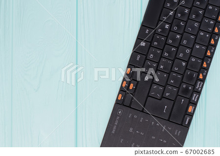 Black computer keyboard on light blue background. Black computer keyboard on light blue background. 67002685