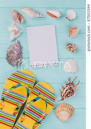 Flat lay composition with sandals, seashells and notepad. Flat lay composition with sandals, seashells and notepad. 67002844